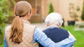 A carer helping a patient with dementia