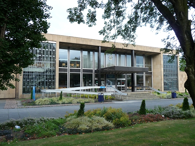 This is a photograph of Huddersfield Magistrates' Court in the daytime with bushes outside.